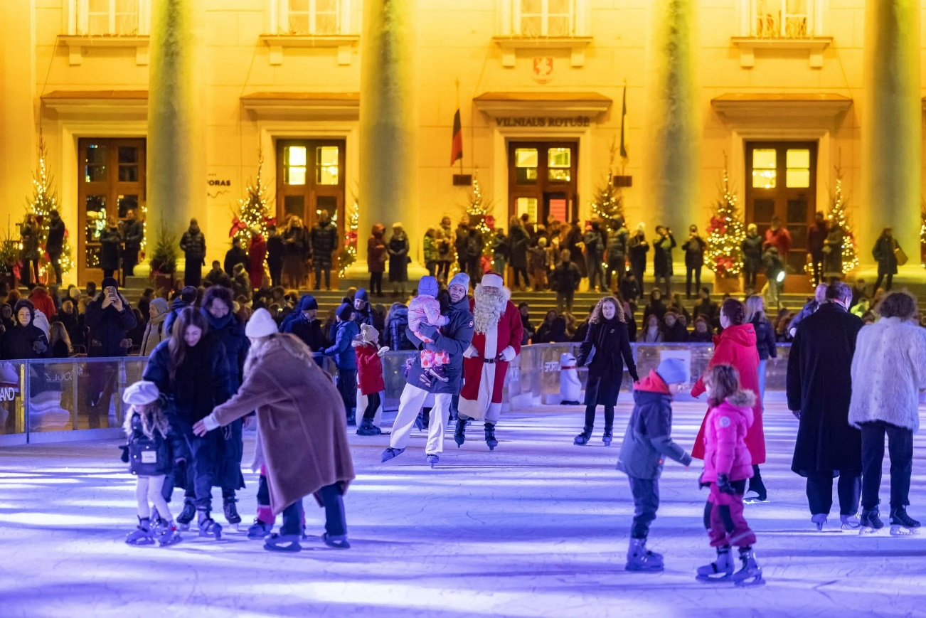 A group of people skating on an ice rinkDescription automatically generated