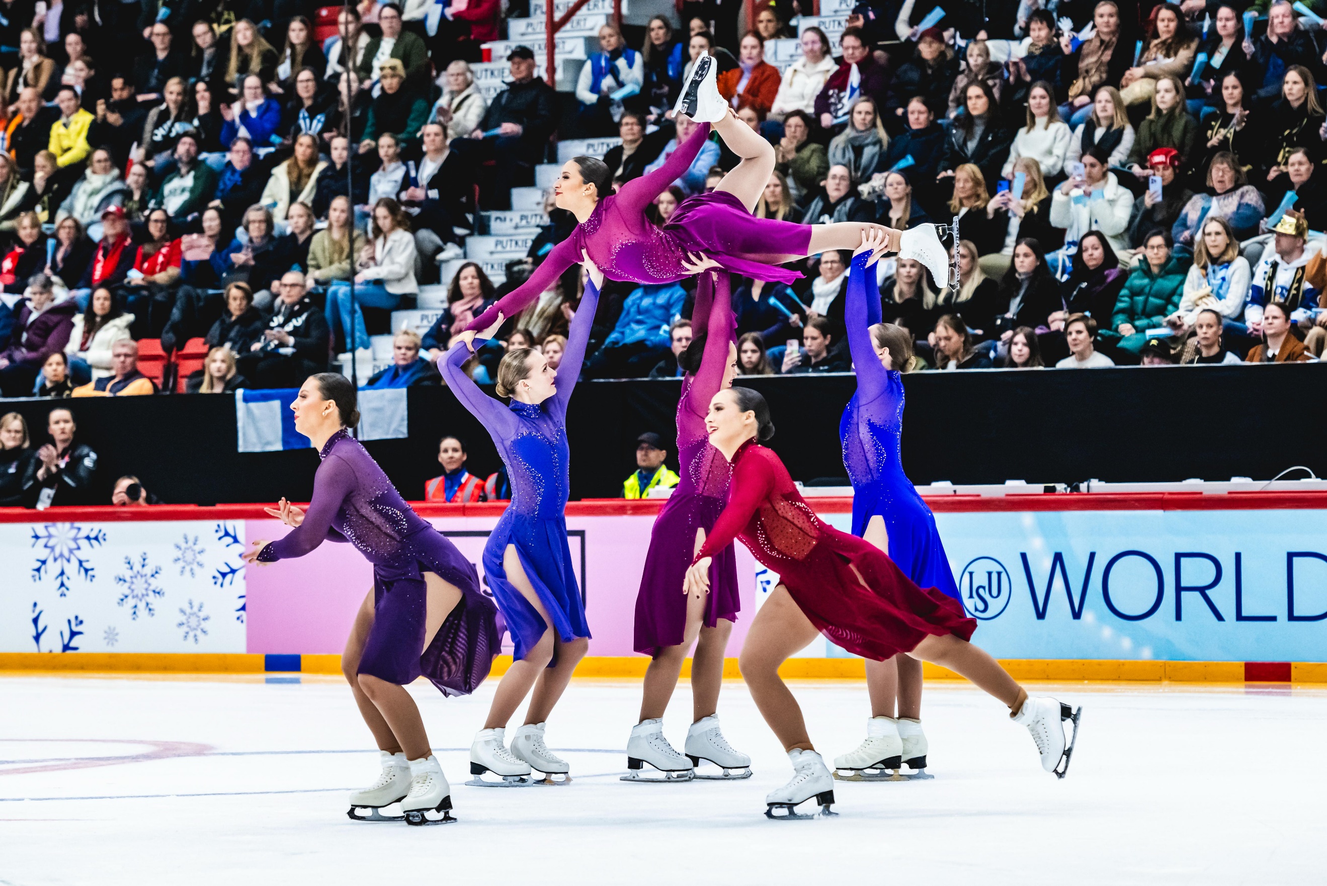 A group of women ice skatingAI-generated content may be incorrect.
