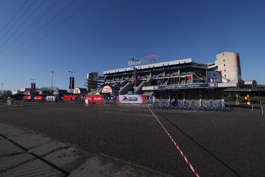 A stadium with people standing in front of itAI-generated content may be incorrect.