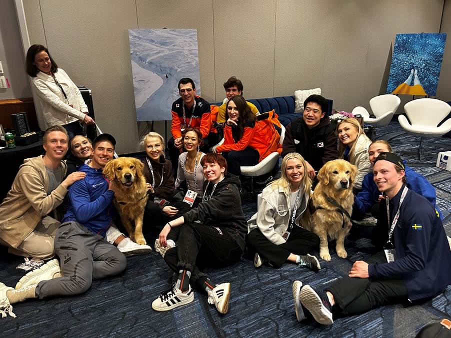 A group of people with dogsAI-generated content may be incorrect.