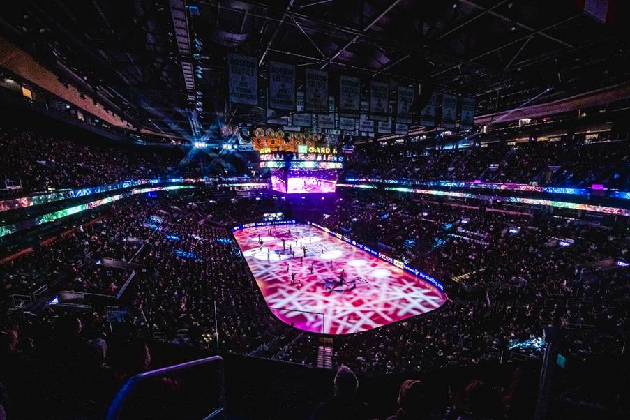 A hockey arena with people watchingAI-generated content may be incorrect.
