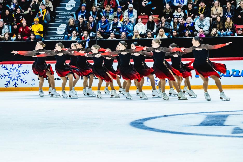 A group of people on ice skatingAI-generated content may be incorrect.