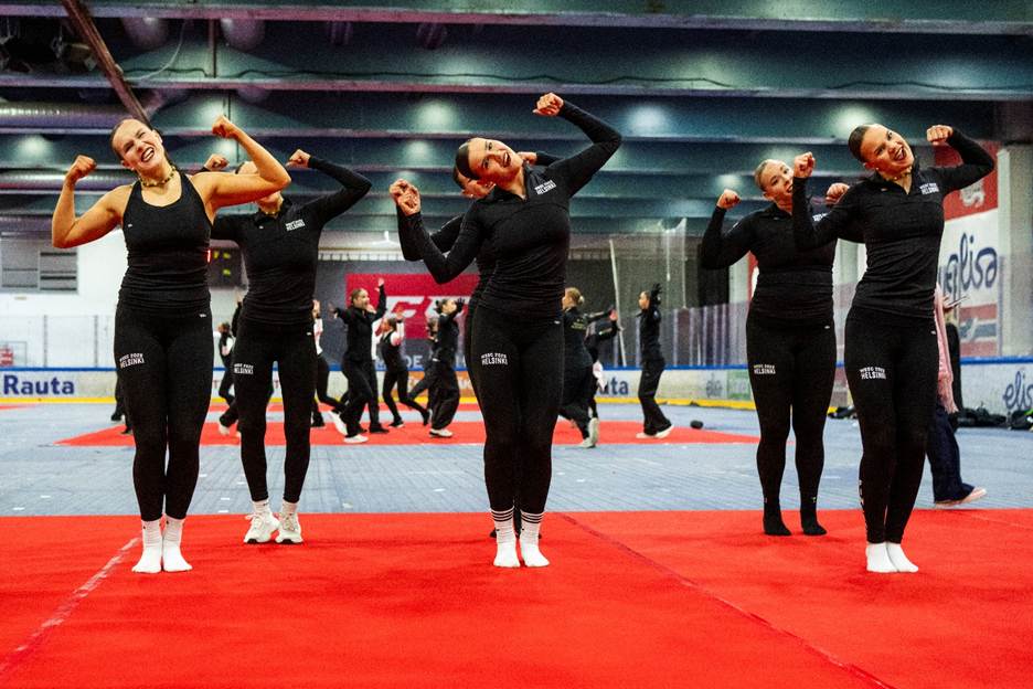 A group of women in black outfits flexing their musclesAI-generated content may be incorrect.